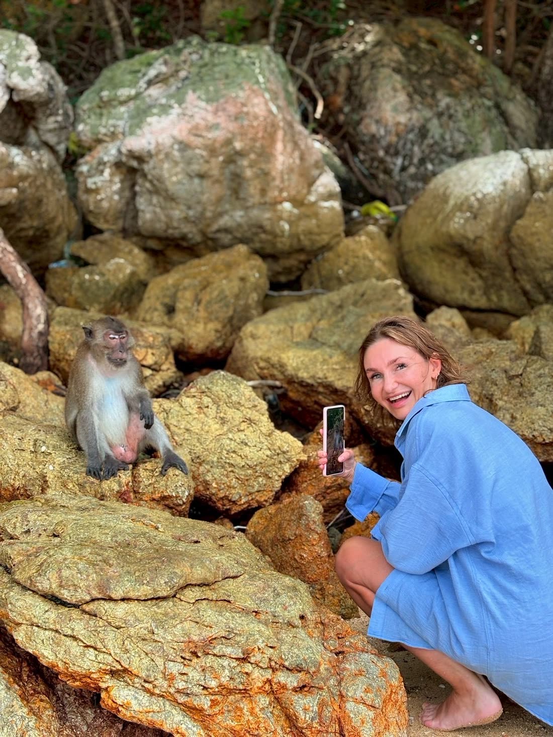 A guest photographing a macaque