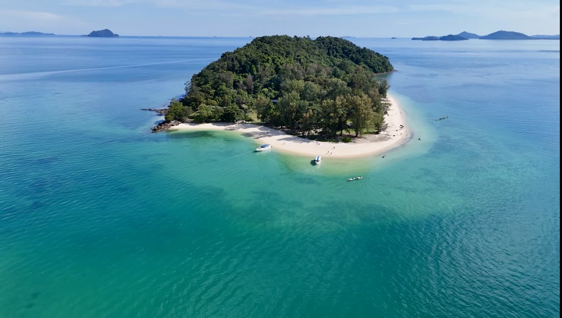 Aerial view of a small island with a white sand spit